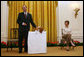 Mrs. Laura Bush looks on as the Westminster Kennel Club's 2008 Best in Show Winner, Uno, and his co-owner Eddie Dziuk address guests during their visit to the White House Monday, May 5, 2008, in the East Room of the White House. White House photo by Shealah Craighead