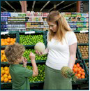 Mom with son selecting fruit