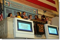 Mrs. Laura Bush is applauded as she stands over the New York Stock Exchange Monday, Sept. 18, 2006, where she visited to highlight literacy's role in extending the benefits of free enterprise to individuals around the world.  White House photo by Shealah Craighead