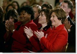 Laura Bush listsens with Assistant Secretary for Health (acting) Dr. Cristina Beato, center, and heart attack survivor Joyce Cullen, left, during White House ceremonies to launch American Heart Month. The event, part of the national Heart Truth campaign, was held to highlight the issue of heart disease as the number-one killer of women in the United States. Monday, Feb. 2, 2004.  White House photo by Susan Sterner