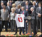 President George W. Bush holds a New York Giants jersey, presented to him by Giants wide receiver Amani Toomer Wednesday, April 30, 2008, as part of an event honoring the Super Bowl XLII Champions on the South Lawn of the White House. White House photo by Shealah Craighead