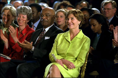 Laura Bush and Education Secretary Rod Paige listen to a speaker during the White House Conference on Character and Community, June 19, 2002. White House photo by Paul Morse.