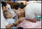 Ms. Barbara Bush, daughter of President George W. Bush and Mrs. Laura Bush, spends a playful moment with a small child during her visit to the Mae Tao Clinic at the Mae La Refugee Camp in Mae Sot, Thailand Thursday, Aug. 7, 2008. White House photo by Shealah Craighead