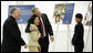 President George W. Bush embraces Usanee Janngeon, Executive Director of Mercy Centre, during a tour upon his arrival Thursday, Aug. 7, 2008, to The Human Development Foundation-Mercy Center, a non-profit organization to help educate and improve the health and welfare of poor children in Bangkok. The tour was led by Father Joe Maier, Director of The Human Development Center of Mercy Centre, left. White House photo by Eric Draper