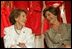 Laura Bush and former First Lady Nancy Reagan share a moment Thursday, May 12, 2005, at the John F. Kennedy Center for the Performing Arts during the unveiling of The Heart Truth’s First Ladies Red Dress Collection.