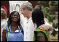 President George W. Bush talks with two women Wednesday, Feb. 20, 2008, during his visit to the International Trade Fair Center in Accra, Ghana. White House photo by Eric Draper