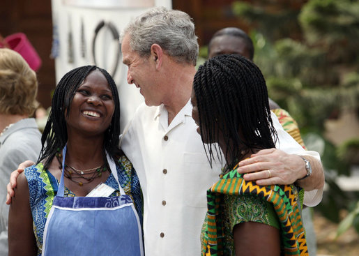 President George W. Bush talks with two women Wednesday, Feb. 20, 2008, during his visit to the International Trade Fair Center in Accra, Ghana. White House photo by Eric Draper