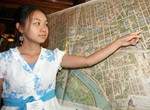 Pang Xiong pointing to a spot on a map.