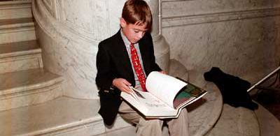 A young member of the International Wizard of Oz Club carefully reviews a pre-publication copy of the annotated Wizard of Oz by Oz historian and L. Frank Baum biographer Michael Patrick Hearn. The Library and the International Wizard of Oz Club recently hosted a centennial celebration marking the first publication of Baum's The Wonderful Wizard of Oz.