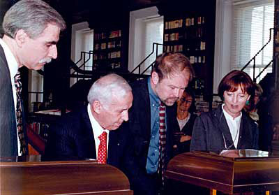 Mr. Panini (second from left) describes the illumination and special binding of the bible to Donald Panzera, John Van Oudenaren, chief of European Division, and Carol Armbruster.