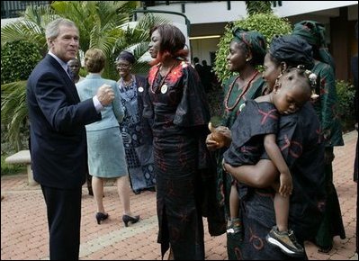 President George W. Bush talks with women who are members of Women and Children of Hope and the Nigerian Community of Western Living with AIDS at National Hospital in Abuja, Nigeria on July 12, 2003.