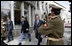 President George W. Bush is accompanied by Afghan President Hamid Karzai at the Presidential Palace in Kabul after President and Mrs. Bush landed in Afghanistan for a brief visit en route to India. During their five-hour stop, they participated in a ceremonial ribbon-cutting at the U.S. Embassy and visited with troops at Bagram Air Base north of the city.