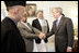 President George W. Bush meets members of President Hamid Karzai's government upon his arrival for a working lunch at the Presidential Palace in Kabul, Afghanistan Wednesday, March 1, 2006.