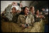 U.S. and Coalition troops cheer and take photos Wednesday, March 1, 2006, during an appearance by President George W. Bush and Mrs. Laura Bush at Bagram Air Base in Afghanistan.