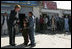 Laura Bush shows a few young boys how to use a kaleidoscope Wednesday, March 30, 2005, during her visit to Afghanistan.  