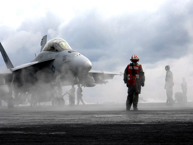 Flight Operations—U.S. Navy sailors observe flight operations aboard the Nimitz-class nuclear-powered aircraft carrier USS Harry S. Truman Jan. 4, 2008.  The ship is under way in the Persian Gulf on a scheduled deployment in support of maritime security operations.