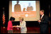 Mrs. Lynne Cheney hands out a copy of “The Citizen’s Almanac,” during a special naturalization ceremony at the National Archives Tuesday, April 17, 2007, in Washington, D.C. White House photo by Lynden Steele