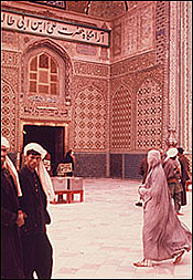 Image: Woman in a burka (actually called a chadri in Afghanistan - burka is a Pakistani term) in front of the shrine of Ali in Mazar-i Sharif, 1975. Grace Brigham.