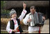 A young boy sings and dances as he's accompanied by an accordionist during a performance for the official NATO Spouses' Program Thursday, April 3, 2008, at the Dimitrie Gusti Village Museum in Bucharest.