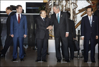 Standing in the grand lobby of the Windsor Hotel Toya Resort and Spa, President George W. Bush shares a moment with President Abdelaziz Bouteflika of Algeria, as they stand for the official G-8 family photo Monday, July 7, 2008, in Toyako, Japan. With them are President Dmitriy Medvedev of Russia, left, and Prime Minister Yasuo Fukuda of Japan, the host of the Summit.