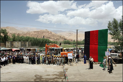 Mrs. Laura Bush, to the right of the podium, is introduced June 8, 2008 by the Governor Habiba Sarabi as workmen prepare to break ground for the Bamiyan Bazaar road project in Afghanistan.
