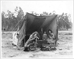 Migrant agricultural worker's family.  [mother and four children in tent]