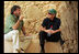 President George W. Bush listens to Eitan Campbell, Director of Masada National Park, as they take a break during their tour Thursday, May 15, 2008, of the historic Israeli fortress located on the eastern fringe of the Judean Desert near the shore of the Dead Sea.