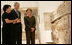 President George W. Bush and Mrs. Laura Bush listen as they're guided through the Bible Lands Museum Jerusalem Friday, May 16, 2008, by Director Amanda Weiss. The museum illustrates the cultures of all the peoples mentioned in the Bible and was founded by the late Dr. Elie Borowski, whose motto remains, "the future of mankind has its roots in the past, and only through understanding our history can we work together to create a better future for the generations to come".