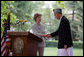 Mrs. Laura Bush shakes hands with President Hamid Karzai of Afghanistan, Sunday, June 8, 2008, during their press availability at the presidential palace in Kabul. White House photo by Shealah Craighead