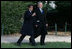 President George W. Bush and President Nicolas Sarkozy share a moment as they walk to a joint press availability Wednesday, Nov. 7, 2007, at Mount Vernon. The tour of the Virginia home of George Washington coincided with a series of meetings by the two leaders during the visit by the French leader to the United States.