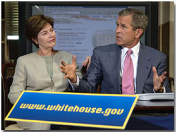 Guided by White House Webmaster Jane Cook (not pictured), President Bush and Laura Bush tour through the new, restructured White House website in the historic Dwight D. Eisenhower Executive Office Building Library Aug. 31. The new site is more accessible for the disabled community, photo essays, a Spanish section and a kids' page. White House photo by Eric Draper. 