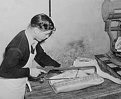 Photo:  butcher sawing a large piece of meat.