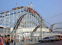 Photo:  Large wooden roller coaster with the sign , "Cyclone" on it.