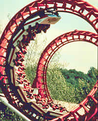 Photo:  Steel roller coaster with cars going upside down in a loop.