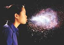 Photo: girl sneezing; a light highlights the resulting wet spray.