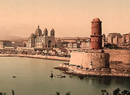 Colorized postcard of river, lighthouse and cathedral  in the distance,