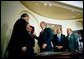 President George W. Bush signs the Do Not Call Registry in the Roosevelt Room Sept. 29, 2003. Pictured with the President are, from left, Rep. Edward Markey, D-Mass.; Rep. Fred Upton, R-Mich.; Federal Trade Commission Chairman Timothy Muris; Rep. Billy Tauzin, R-La. (behind President Bush); Federal Communications Commission Chairman Michael Powell; and Sen. Ted Stevens, R-Alaska. White House photo by Eric Draper.