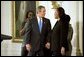 President George W. Bush congratulates Pamela Hedrick during a ceremony honoring graduates of welfare-to-work programs in the East Room. Ms. Hedrick was on public assistance for eight years in Columbus, Ohio, before volunteering at the Greenbriar Enrichment Center, where she organized a women's support group and received job training. The President’s Council of Economic Advisers (CEA) estimates the Jobs and Growth plan will create 1.4 million new jobs by the end of 2004. White House photo by Tina Hager.