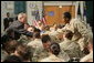 President George W. Bush reaches out to a sailor Sunday, Jan. 13, 2008, during breakfast at the U.S. Naval Forces Central Command in Manama, Bahrain. The President spent the first part of his morning dining with military personnel and coalition forces before departing Bahrain for Abu Dhabi, United Arab Emirates. White House photo by Eric Draper