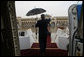 With umbrella in hand, President George W. Bush waves from aboard Air Force One as he prepares to deplane after arriving Sunday, Jan. 13, 2008, at Abu Dhabi International Airport. White House photo by Eric Draper