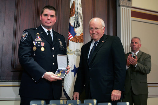 Vice President Dick Cheney awards Washington, D.C., Amtrack Police Officer Rodney Lee Chambers the Public Safety Officer Medal of Valor Award Thursday, July 14, 2005, during a ceremony in the Dwight D. Eisenhower Executive Office Building. The Medal of Valor is awarded to public safety officers cited by the Attorney General for extraordinary courage above and beyond the call of duty. Officer Chambers was on patrol June 9, 2003, at Union Station when reports came in regarding a man seen with a grenade. After Officer Chambers located and stopped the subject , the man pulled the pin. Officer Chambers grabbed the grenade and squeezed it, not allowing it to detonate. Officer Chambers waited roughly 20 minutes for the bomb disposal officers to arrive and dispose of the device. The device was later determined to be inoperable, yet this was unknown to Chambers at the time of the incident. White House photo by David Bohrer