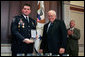 Vice President Dick Cheney awards Washington, D.C., Amtrack Police Officer Rodney Lee Chambers the Public Safety Officer Medal of Valor Award Thursday, July 14, 2005, during a ceremony in the Dwight D. Eisenhower Executive Office Building. The Medal of Valor is awarded to public safety officers cited by the Attorney General for extraordinary courage above and beyond the call of duty. Officer Chambers was on patrol June 9, 2003, at Union Station when reports came in regarding a man seen with a grenade. After Officer Chambers located and stopped the subject , the man pulled the pin. Officer Chambers grabbed the grenade and squeezed it, not allowing it to detonate. Officer Chambers waited roughly 20 minutes for the bomb disposal officers to arrive and dispose of the device. The device was later determined to be inoperable, yet this was unknown to Chambers at the time of the incident. White House photo by David Bohrer