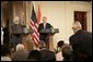 President George W. Bush and India's Prime Minister Dr. Manmohan Singh, listen to a reporter's question during a joint news conference, Monday, July 18, 2005, in the East Room of the White House. White House photo by Eric Draper