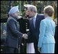 President George W. Bush and Laura Bush welcome India's Prime Minister Dr. Manmohan Singh upon his arrival to the White House, Monday, July 18, 2005. White House photo by Eric Draper