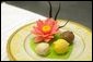 Three ice creams presented on a white chocolate lily pad with a lotus flower. White House Executive Pastry Chef Thaddeus DuBois created for the Official Visit of the Prime Minister of India July 18, 2005. White House photo by Shealah Craighead