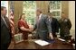 President George W. Bush shakes the hands of Janet and Bill Norwood after signing into law H.R. 1001, the Naming of the Sergeant Byron W. Norwood Post Office Building, designating the US Postal Service facility in Pflugerville, Texas, in honor of their 25-year-old son who died in combat in Iraq. Joining the Norwoods and the President for the signing are Congressman Michael McCaul, R-Texas, and First Lt. T.Ryan Sparks, 3rd Battalion, 1st Marines. White House photo by Eric Draper