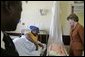 Laura Bush visits with a mother and her newborn baby while meeting with the group, "Mothers to Mothers-to-Be," in Cape Town, South Africa, Tuesday, July 12, 2005. The program provides support to HIV-positive women during their pregnancy. White House photo by Krisanne Johnson