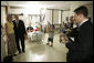 President George W. Bush poses with Stacy Beintema, the mother of Specialist Nicholas Beintema of Woodbridge, Calif., during a visit with wounded soldiers and their families at Walter Reed Army Medical Hospital Friday, July 1, 2005. White House photo by Eric Draper