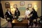 President George W. Bush, Bono, Laura Bush and Bob Geldof, far right, hold a working meeting on Africa at the G8 Summit in Gleneagles, Scotland, Wednesday, July 6, 2005. White House photo by Eric Draper