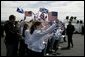 President George W. Bush and Laura Bush are greeted by ceremony and cheers upon their arrival at Glasgow Prestwick International Airport in Scotland July 6, 2005. White House photo by Krisanne Johnson